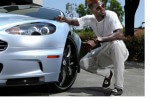 picture of Togolese and Tottenham Hotspurs Adebayor beside his Fisker Karma