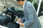Picture of a man verifying vehicle details manually