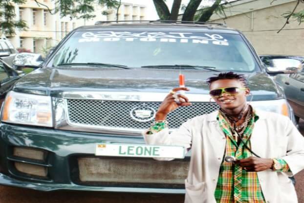 Image of Chameleone posing beside his Cadillac Escalade