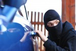 image of a thief stealing a car