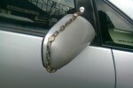 image of a chained Toyota Wish side mirror