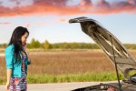 Image of a woman repairing a car