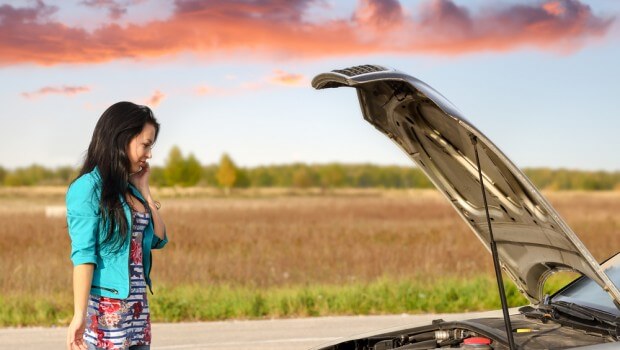 Image of a woman repairing a car