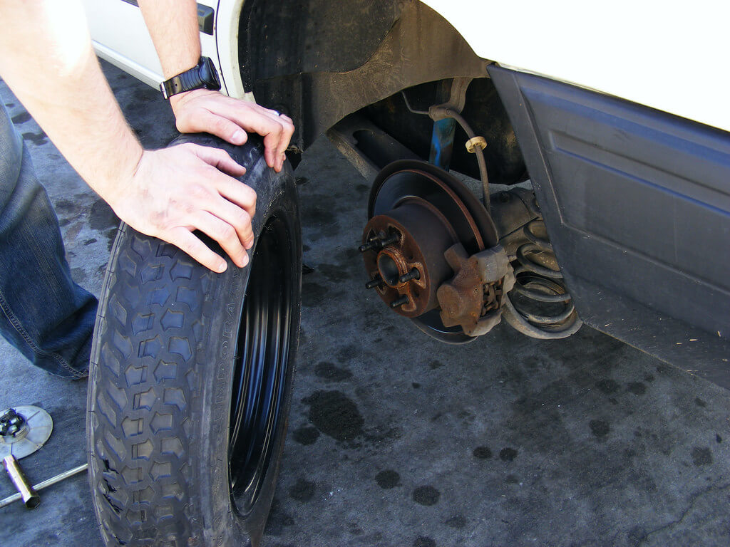 changing tire How to Maneuver Your Car Safely After a Tire Blowout
